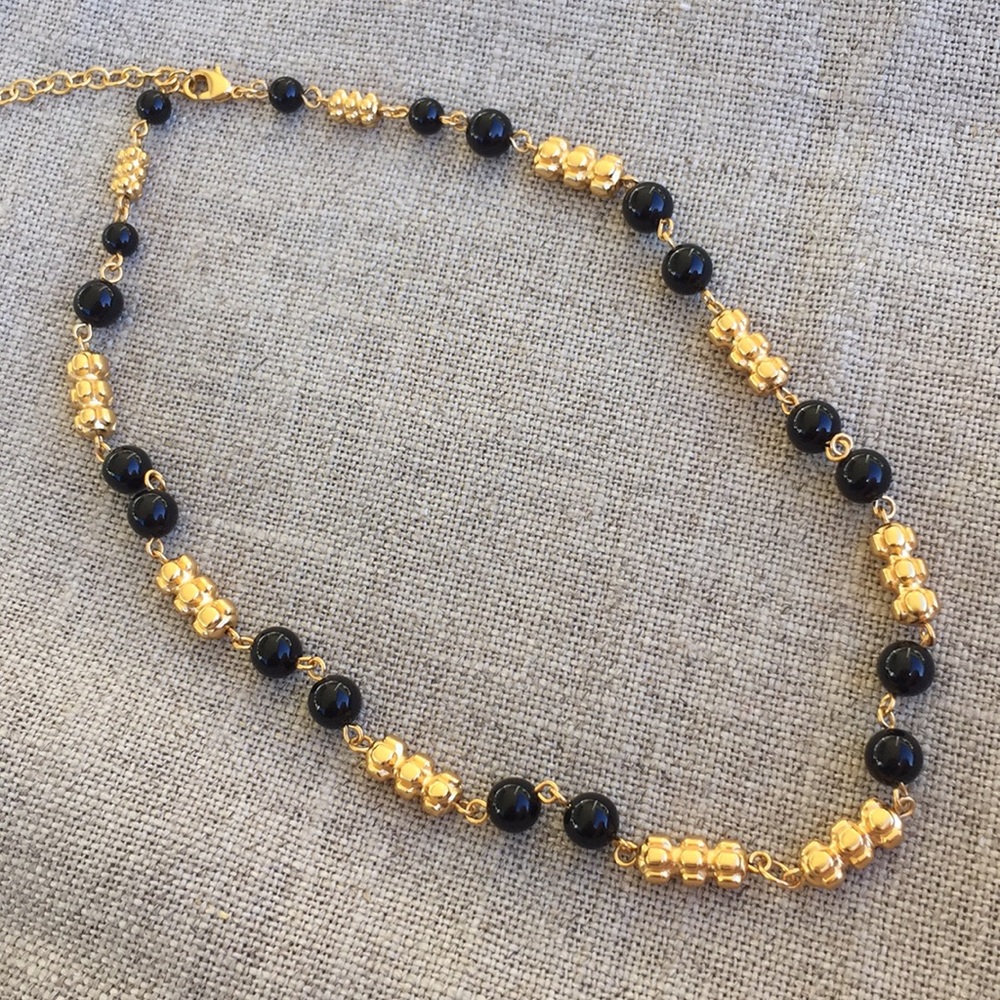 In a gold necklace.